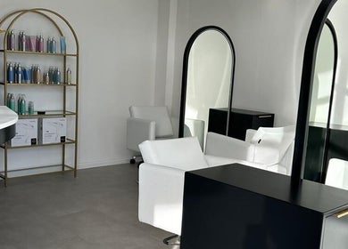 Modern salon interior at Alchemy Hair & Beauty, Cape Town, Western Cape, ZA. Elegant mirrors and chairs.