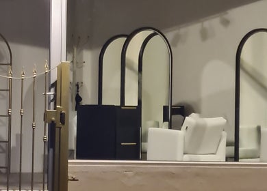 Stylish interior of Alchemy Hair & Beauty, showcasing mirrors and seating in Cape Town, Western Cape, ZA.