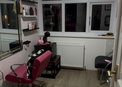 Cozy salon area at Zoe Lottie - Hair in Shinfield, England, GB, featuring stylish decor and a pink salon chair.