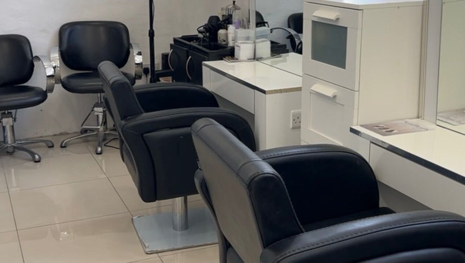 Elegant salon setup at Suki Hair and Beauty in Blackburn, England, GB featuring stylish black chairs.