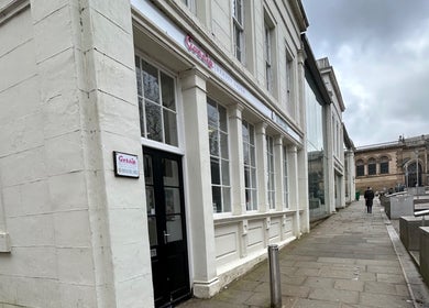 Exterior of Suki hair and beauty in Blackburn, England, GB showcasing elegant salon facade on a cloudy day.