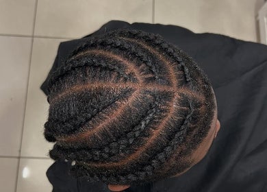 Intricate braided hairstyle at Suki hair and beauty, Blackburn, England, GB salon showcasing skilled craftsmanship.