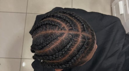 Intricate braided hairstyle at Suki hair and beauty, Blackburn, England, GB salon showcasing skilled craftsmanship.