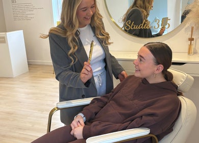 Client enjoys a beauty session at N Dbrows&Beauty, Busby, Scotland, GB. The cozy interior enhances the experience.