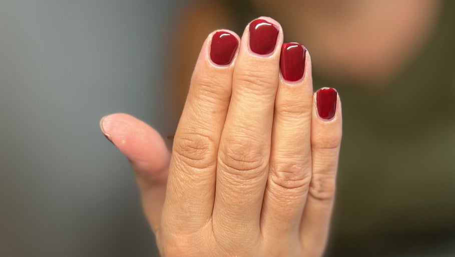 Close-up of elegant red nails at AJ Beauty, Bath, England, GB, showcasing expert manicure services.