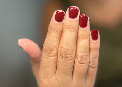 Close-up of elegant red nails at AJ Beauty, Bath, England, GB, showcasing expert manicure services.