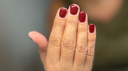 Close-up of elegant red nails at AJ Beauty, Bath, England, GB, showcasing expert manicure services.