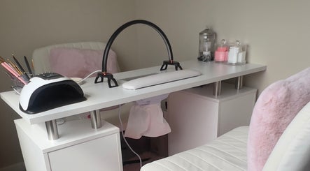 Chic nail station at AJ Beauty, Bath, England, GB, featuring tools and soft pink decor for a relaxing experience.