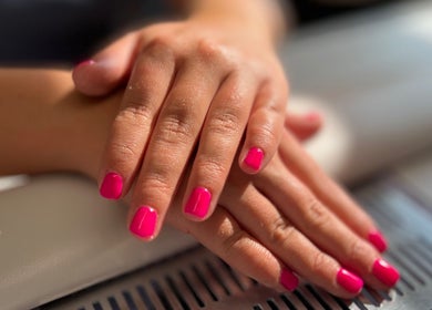 Bright pink manicured nails at AJ Beauty, Bath, England, GB, showcasing elegance and style.