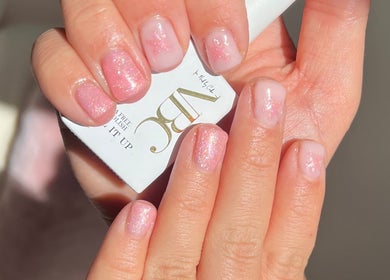 Glittery pink manicure at AJ Beauty in Bath, England, GB, showcasing elegant nail art.