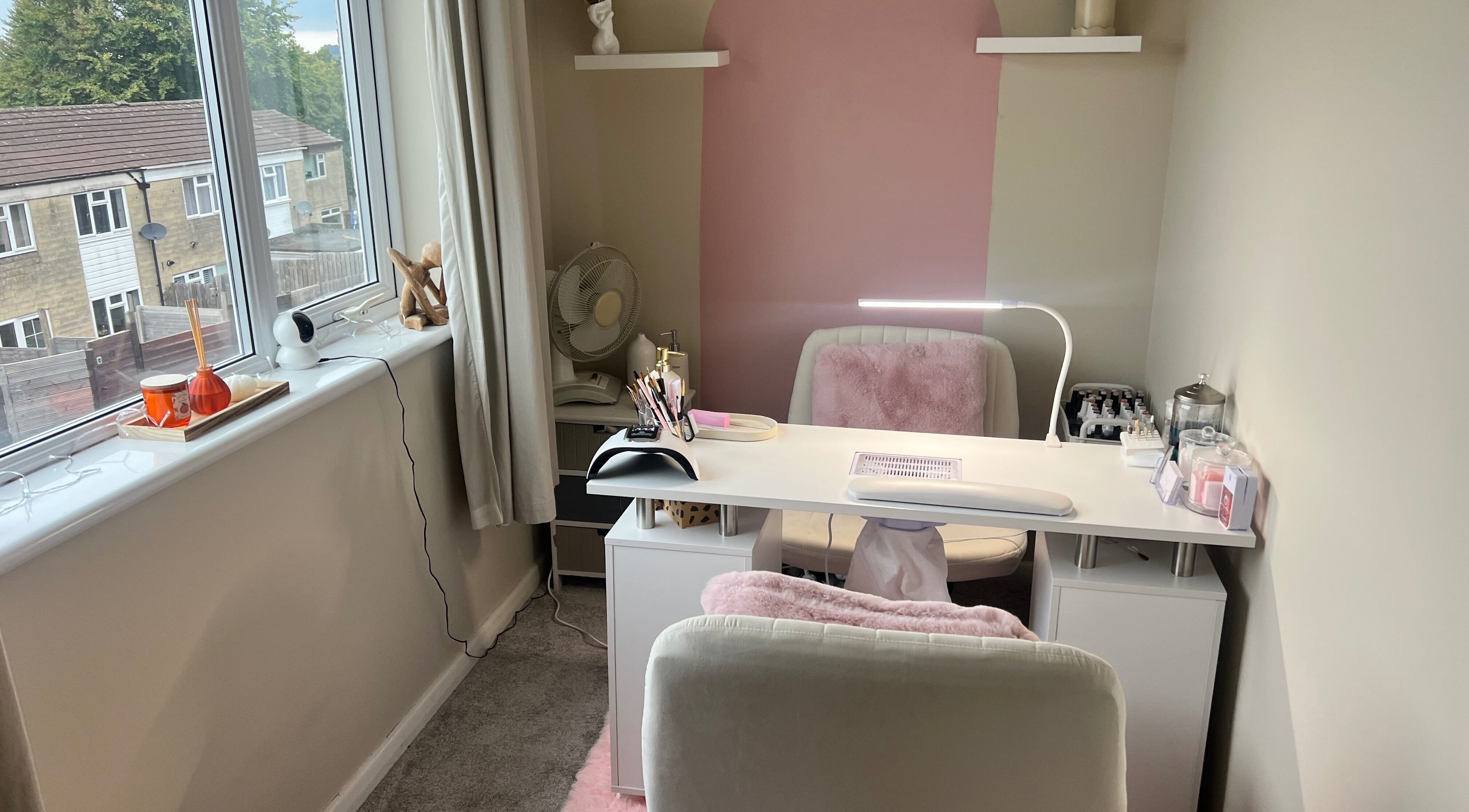 Chic beauty station at AJ Beauty, Bath, England, GB. Modern setup with pink accents and essential tools for wellness.