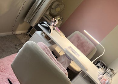 Elegant beauty desk at AJ Beauty, Bath, England, GB, with plush seating and soft lighting for a serene ambiance.