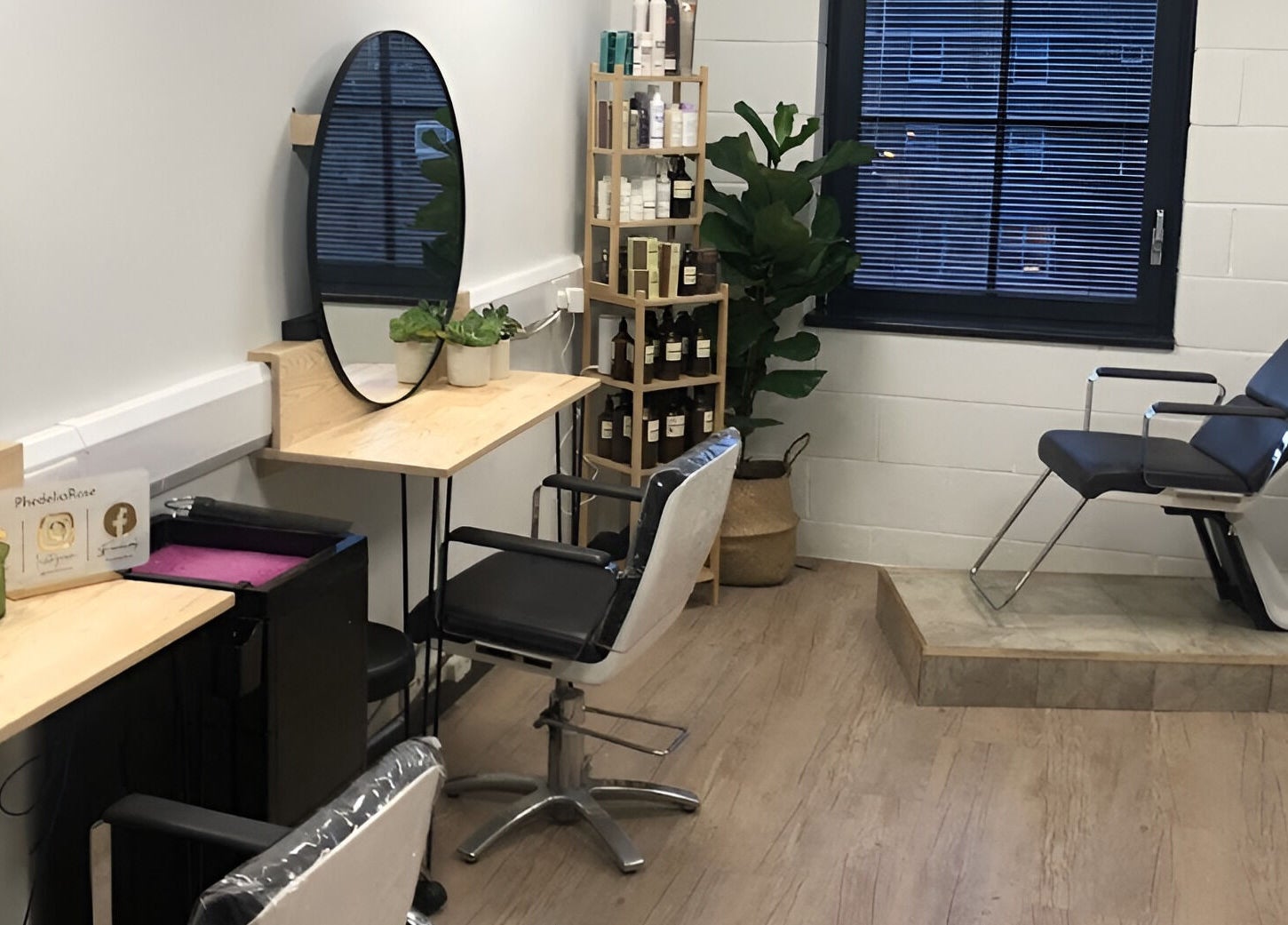 Modern salon interior at PhedeliaRose, London, England, GB, showcasing stylish chairs and product display.