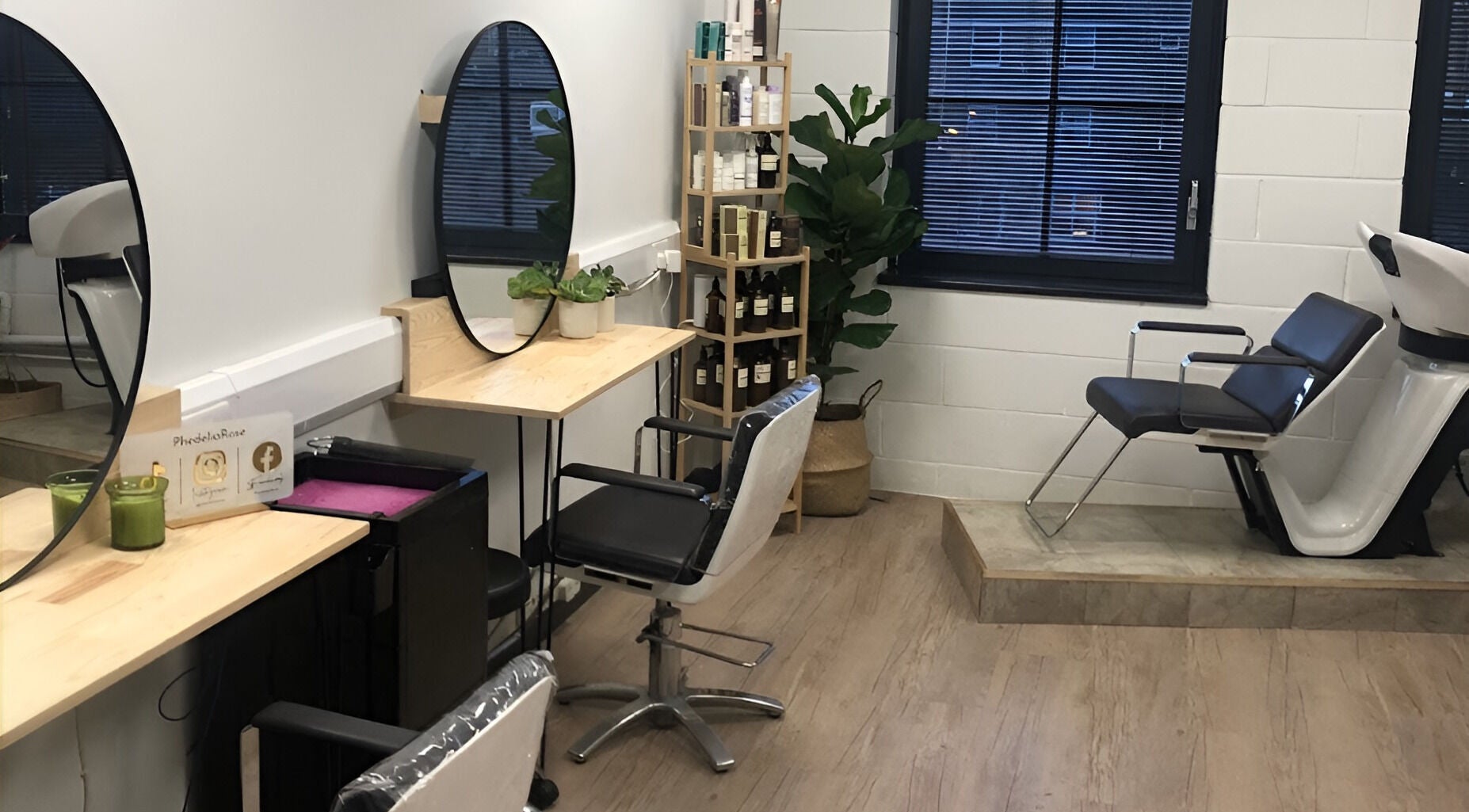 Modern salon interior at PhedeliaRose, London, England, GB, showcasing stylish chairs and product display.