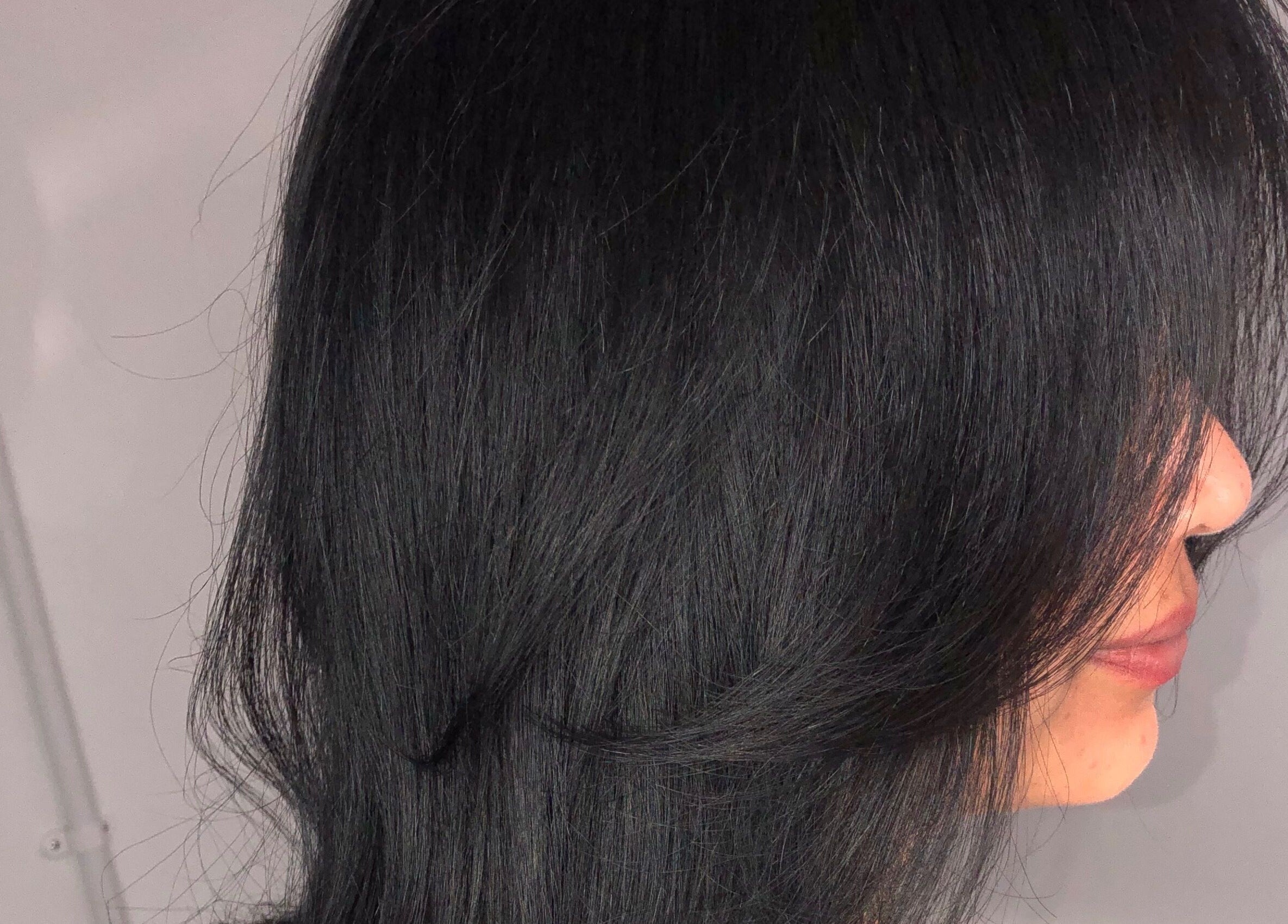 Close-up of sleek, shiny black hair styled at PhedeliaRose, London, England, GB.