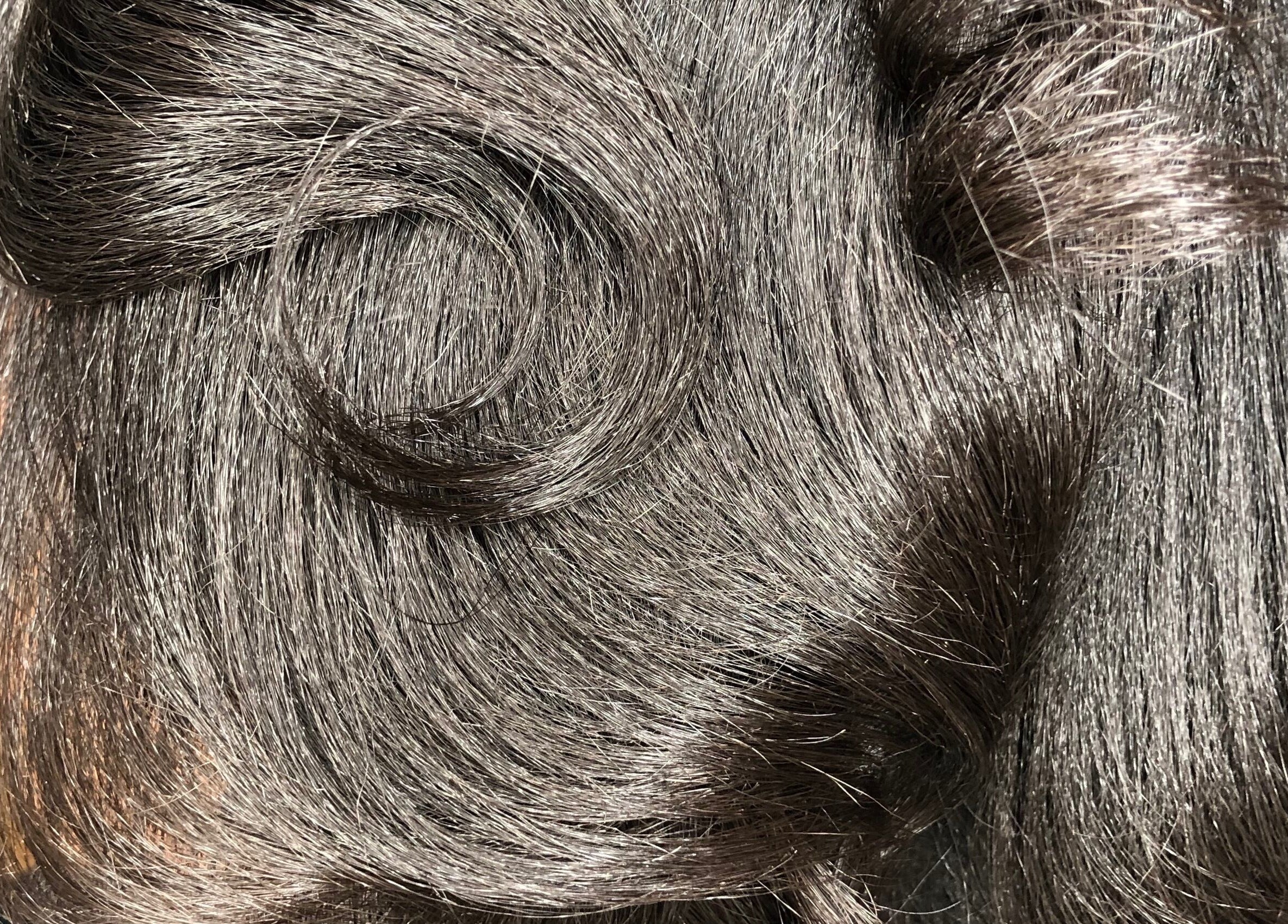 Close-up of shiny, styled hair at PhedeliaRose, London, England, GB, showcasing smooth waves.