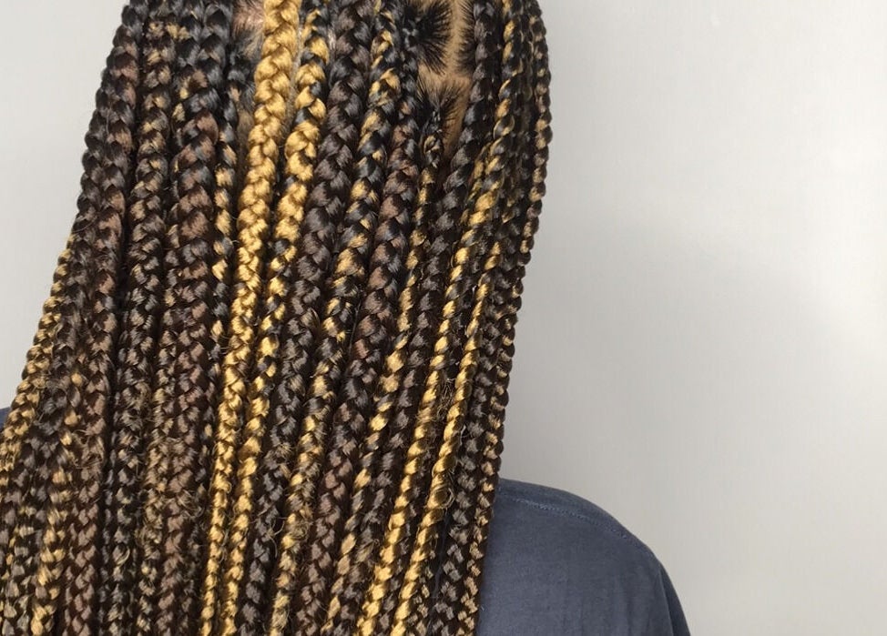 Intricate braided hairstyle with golden highlights at PhedeliaRose, London, England, GB. Perfect for a chic look.