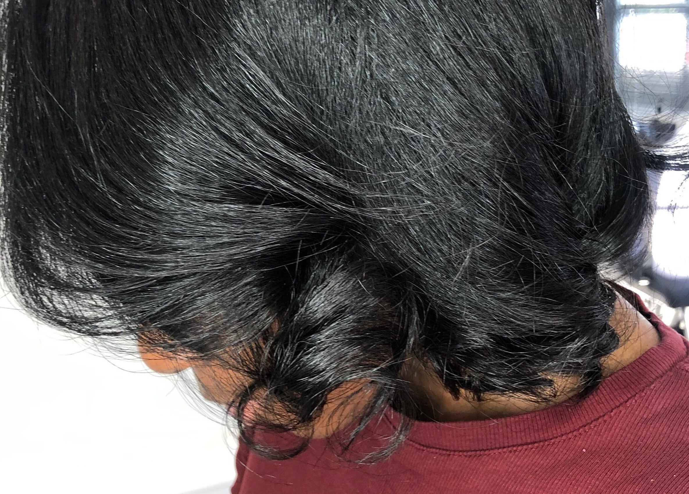 Close-up of shiny black hair styled elegantly at PhedeliaRose in London, England, GB.