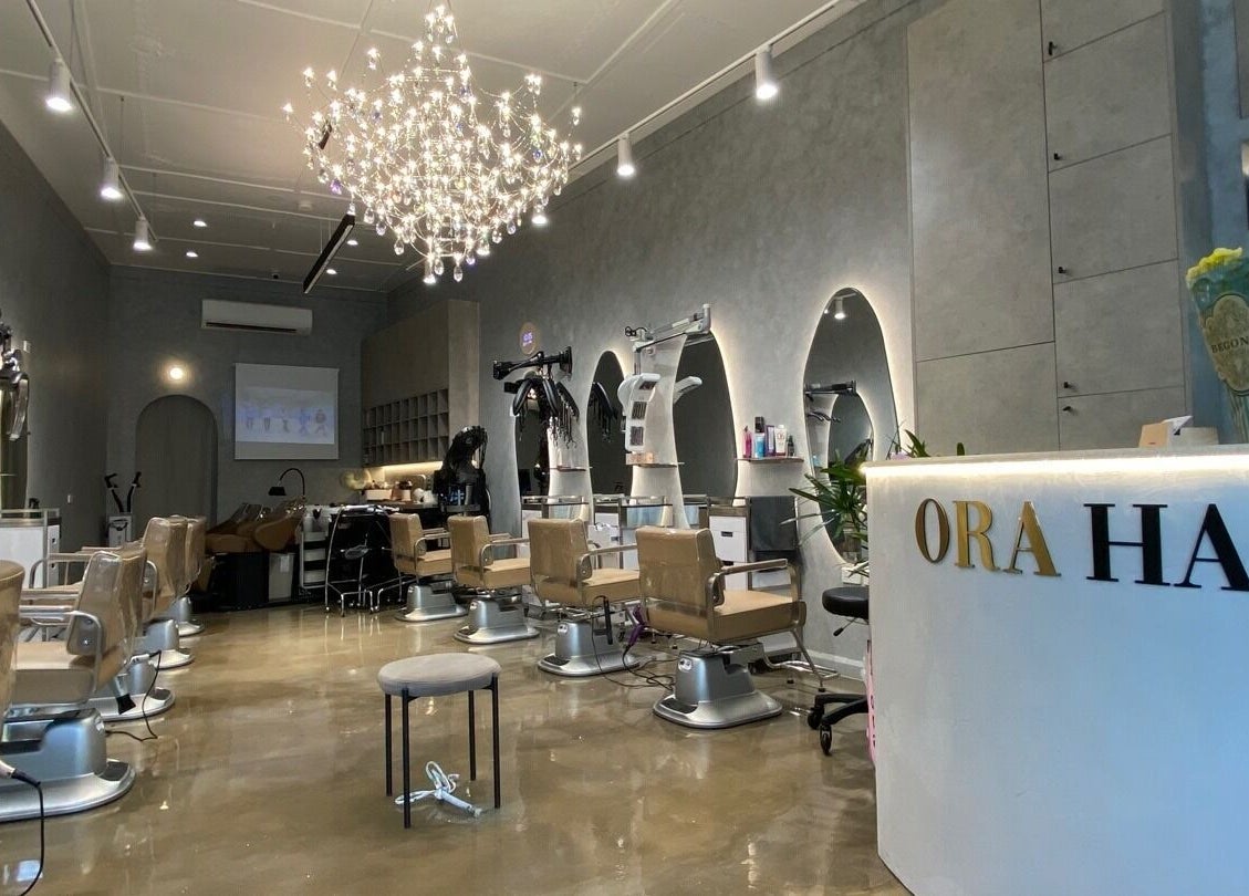 Modern hair salon interior with elegant chandelier at Ora No1, Lidcombe, New South Wales, AU.
