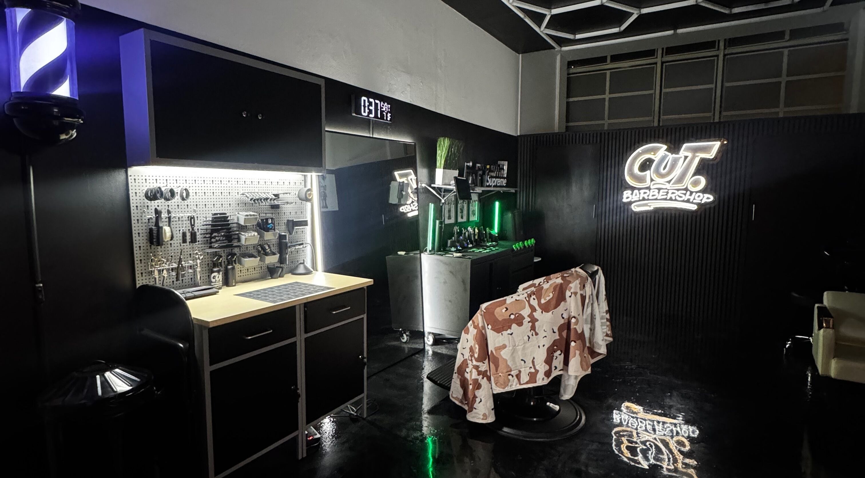 Modern interior of Cut. Barbershop in Birmingham, England, GB featuring high-end barber tools and chairs.