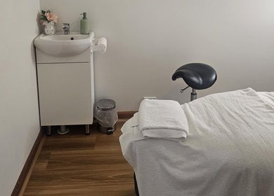 Serene treatment room at KJ Beauty Studio, Mount Helen, Victoria, AU, showcasing a massage table and sink.