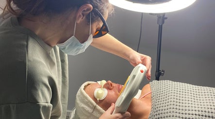 Facial treatment at KJ Beauty Studio, Mount Helen, Victoria. Aesthetician using device on client's face.