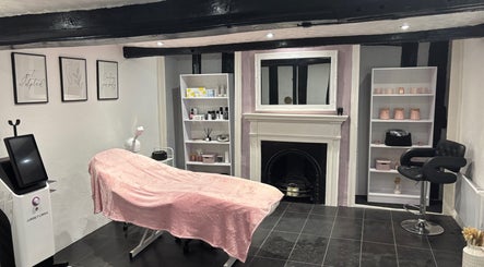 Relaxation area at KM Sculpt & Glow in Congleton, England, featuring a treatment bed and elegant decor.
