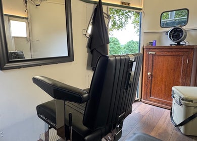 Modern barber chair at Shelly The Barber in Newport, Wales, GB, featuring sleek decor and stylish interior.