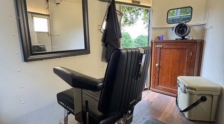 Modern barber chair at Shelly The Barber in Newport, Wales, GB, featuring sleek decor and stylish interior.