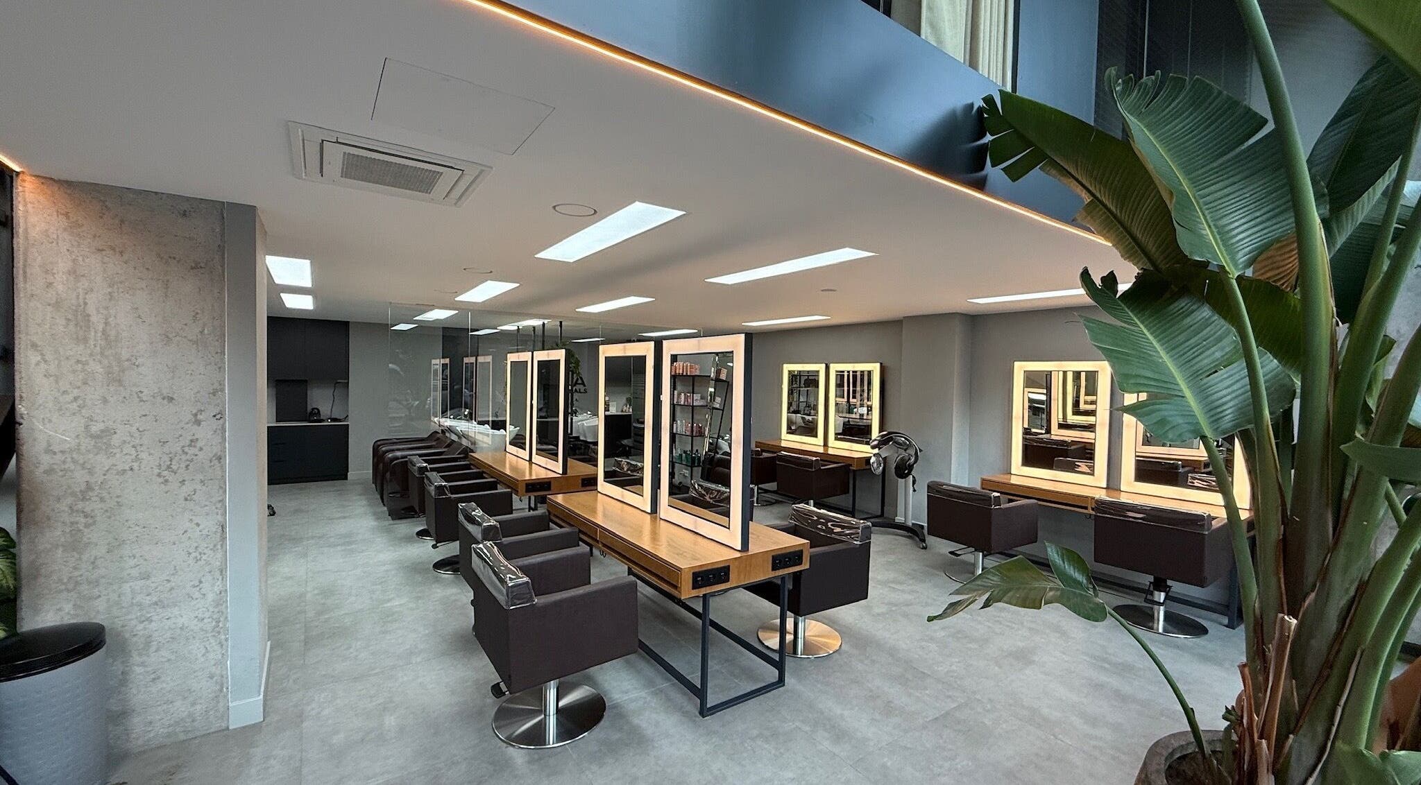 Modern interior of GP Hair Experience in Amsterdam, Noord-Holland, NL, featuring stylish salon stations.