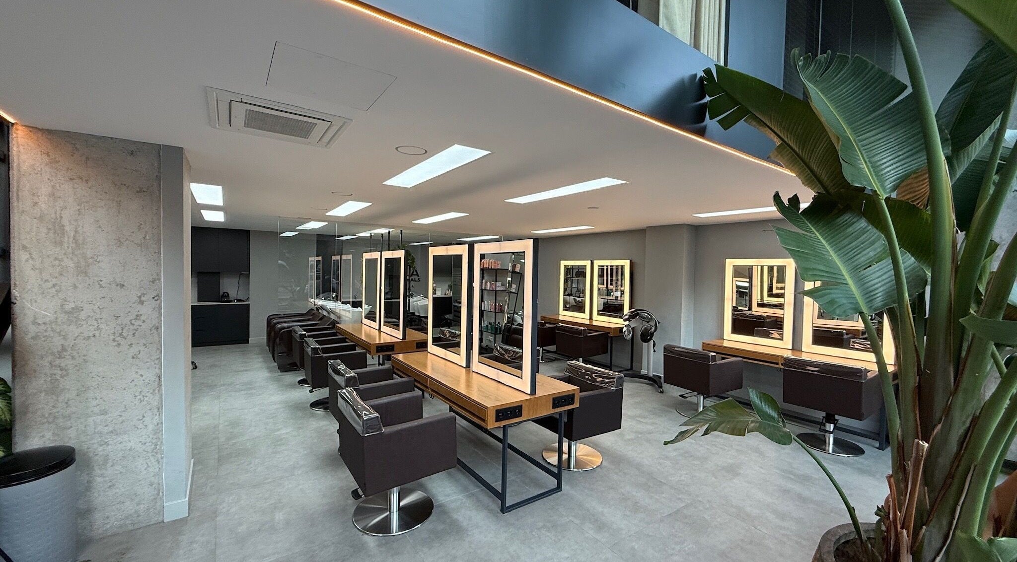 Modern interior of GP Hair Experience in Amsterdam, Noord-Holland, NL, featuring stylish salon stations.