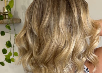 Stylishly curled blonde hair at hair by Holly Stewart, Nambour, Queensland, AU.