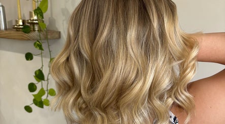 Stylishly curled blonde hair at hair by Holly Stewart, Nambour, Queensland, AU.