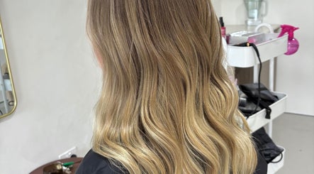 Blonde waves styled at Hair by Holly Stewart in Nambour, Queensland, AU, showcasing vibrant, smooth hair.