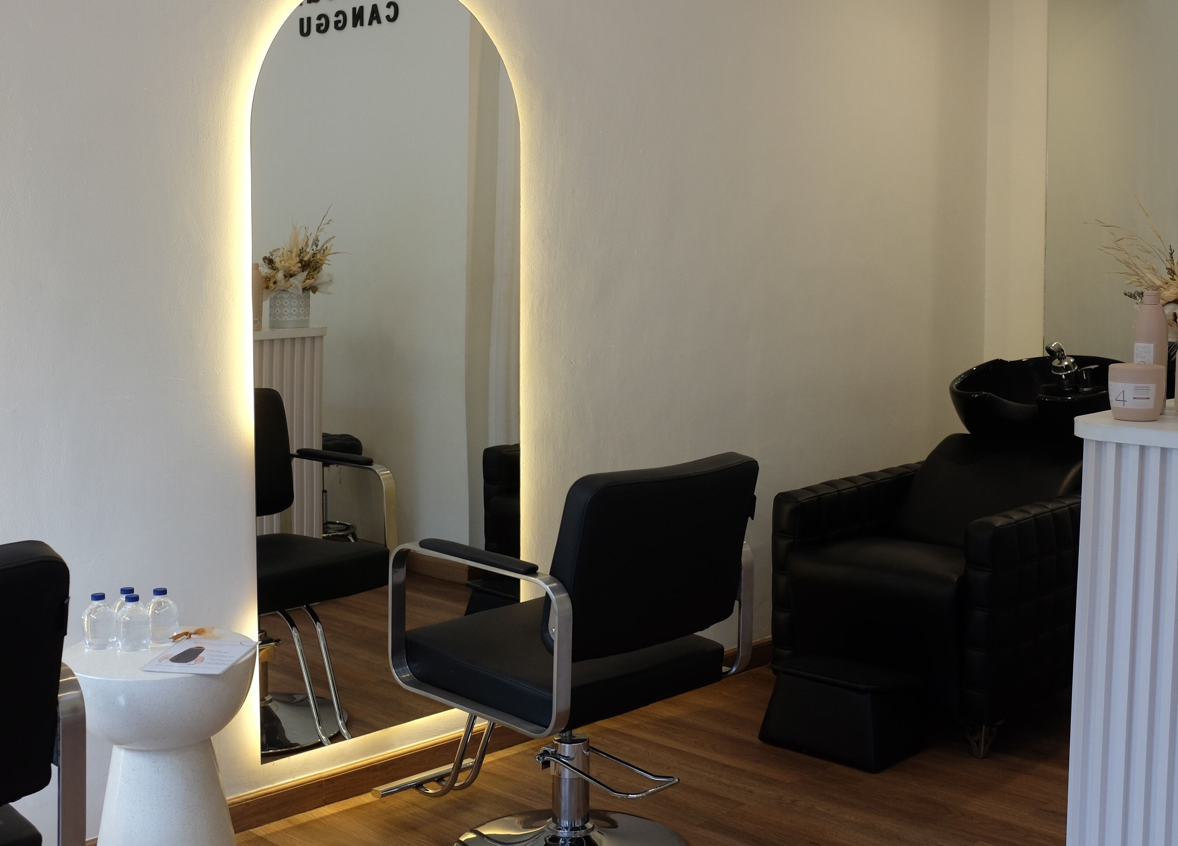Elegant salon interior at Blowdry Boutique Canggu, Bali, Bali, ID, featuring chic black chairs and mirrors.