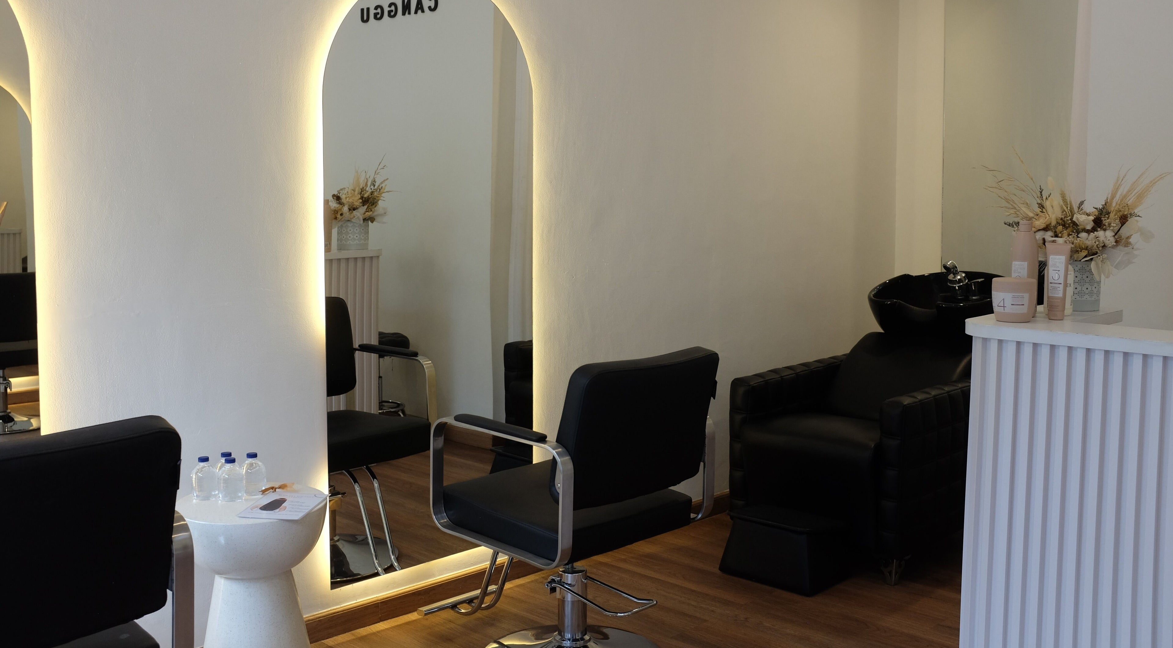 Elegant salon interior at Blowdry Boutique Canggu, Bali, Bali, ID, featuring chic black chairs and mirrors.