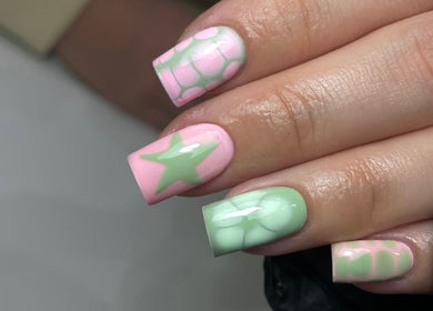 Stylish pastel nail art at ByKayla.Sb, Blackpool, England, GB showcasing pink and green star designs.