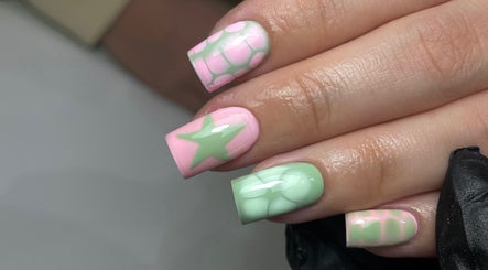 Stylish pastel nail art at ByKayla.Sb, Blackpool, England, GB showcasing pink and green star designs.