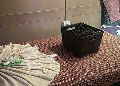 Peaceful massage room at Mystyle Thai Massages, Brisbane City, Queensland, AU with a decorative towel and basket.
