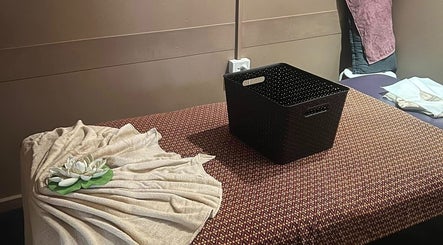 Peaceful massage room at Mystyle Thai Massages, Brisbane City, Queensland, AU with a decorative towel and basket.