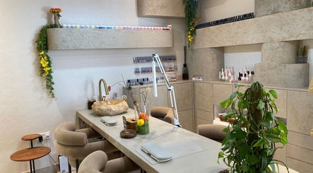 Elegant nail bar at Bali Nails & Lashes, Al Ain, Abu Dhabi, AE. Featuring modern decor and lush plants.