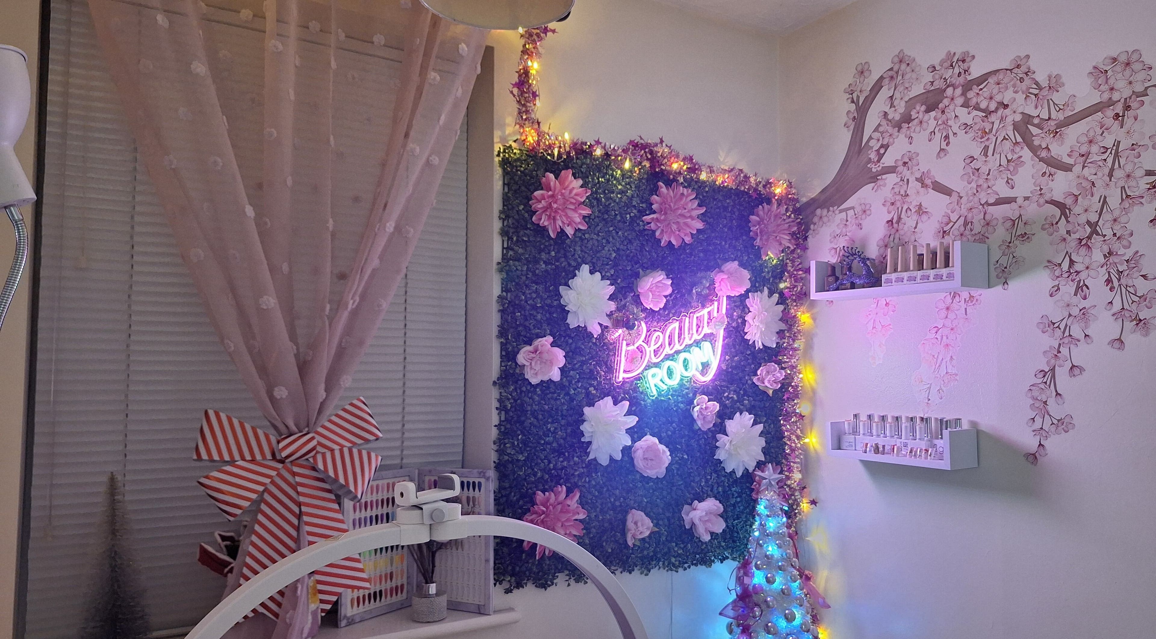 Glam Beauty Room in Whetstone, England, GB features floral decor, neon sign, and cozy ambiance lighting.