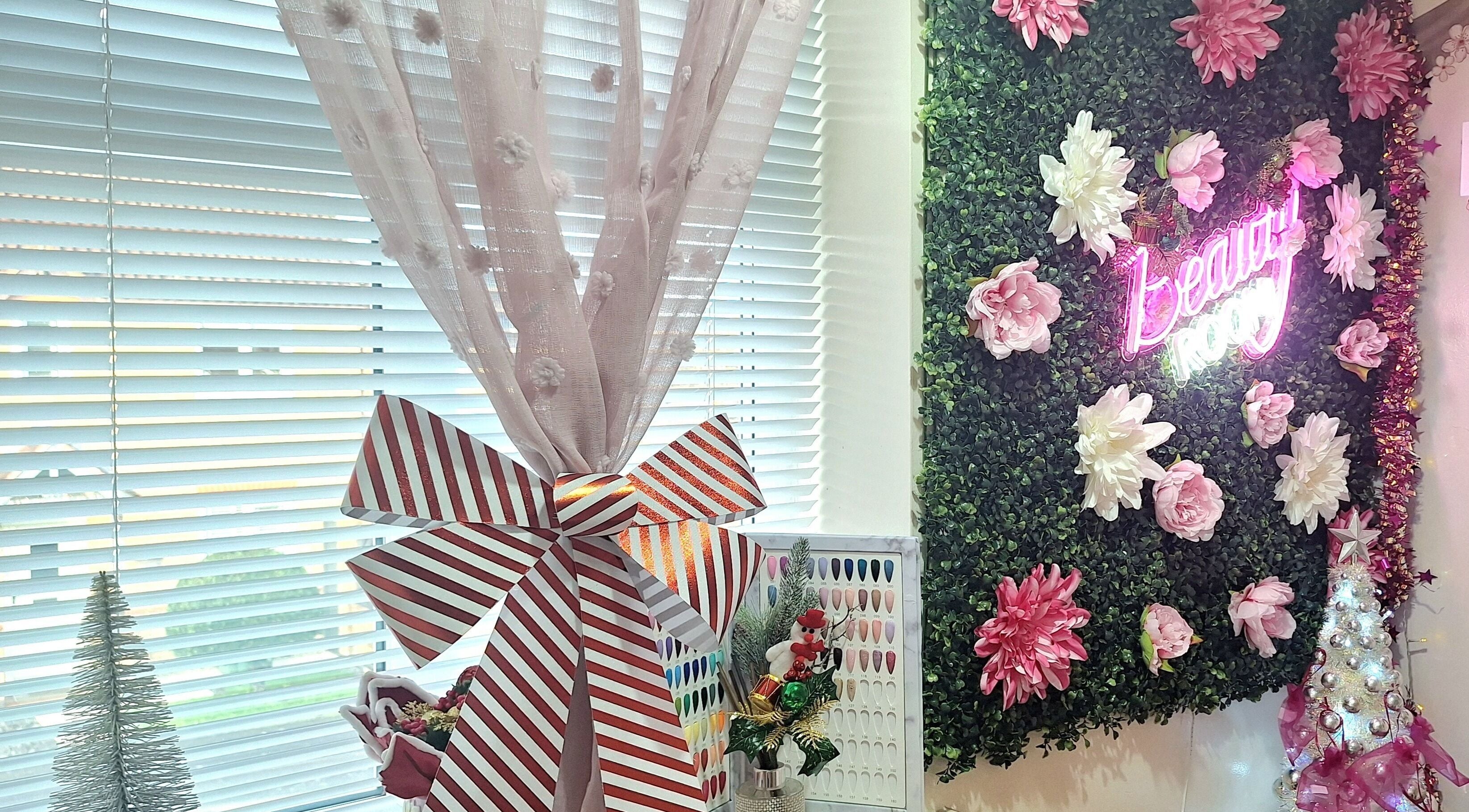 Glam Beauty Room in Whetstone, England: Lush floral wall with 'Beauty' neon sign in vibrant wellness setting.