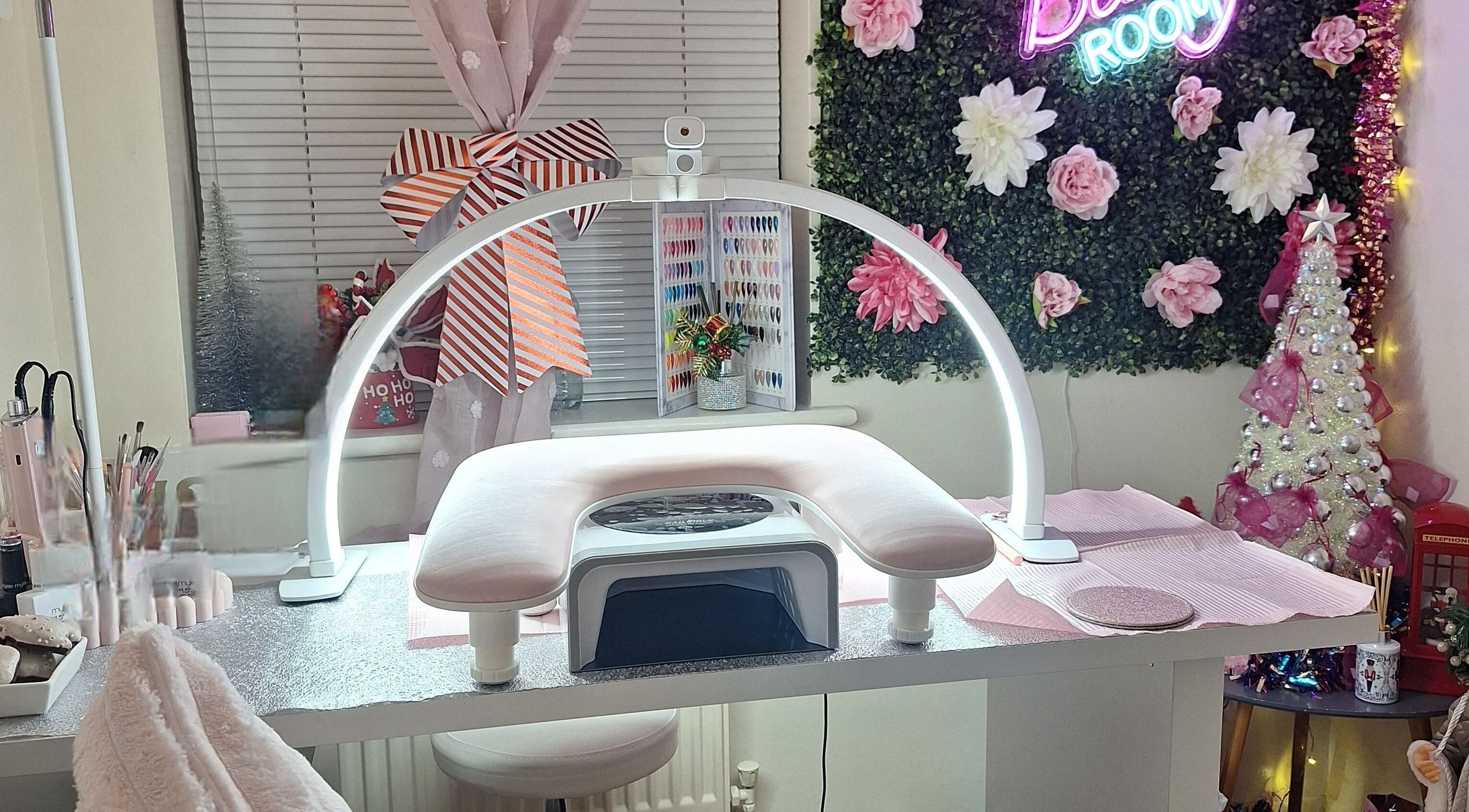 Nail station at Glam Beauty Room, Whetstone, England, GB. Features modern decor with floral accents.