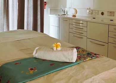 Relaxing massage table at Yoganic Thai Spa and Massage, London, England, GB, set with flower and towel.