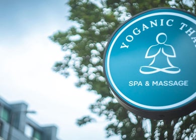 The Yoganic Thai Spa and Massage signboard in London, England, GB, with a serene blue design.