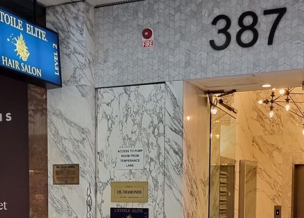 Entrance of L'Etoile Elite in Sydney, New South Wales, AU shows sleek modern design with marble walls.