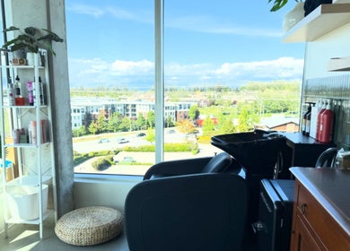View from Summer House Hair Studio in Surrey, BC showing a serene setup with shelves and cityscape.