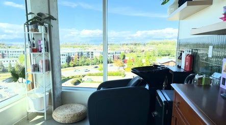 View from Summer House Hair Studio in Surrey, BC showing a serene setup with shelves and cityscape.