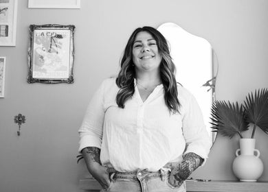Stylist at Summer House Hair Studio in Surrey, British Columbia, CA, stands smiling beside decor.